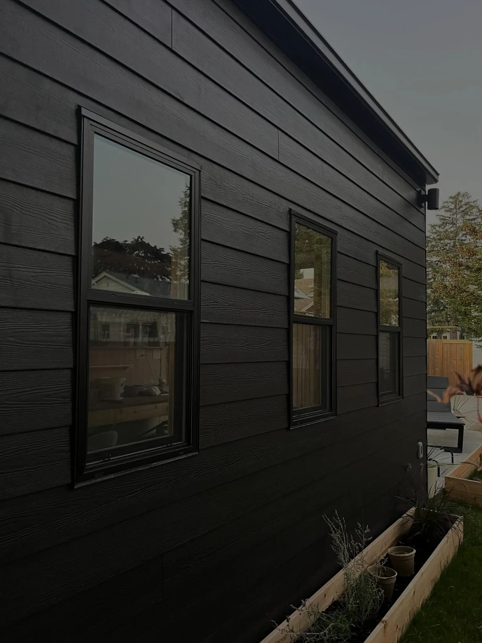 Black horizontal siding with black-framed windows