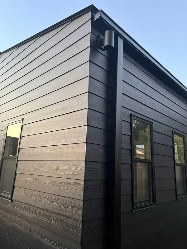 Black horizontal siding on a modern addition