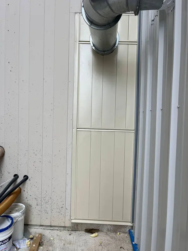Light vertical metal siding with flashing details