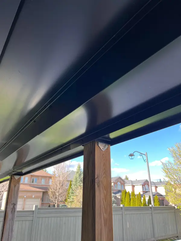 Black metal soffit and beam wrap over a wood post